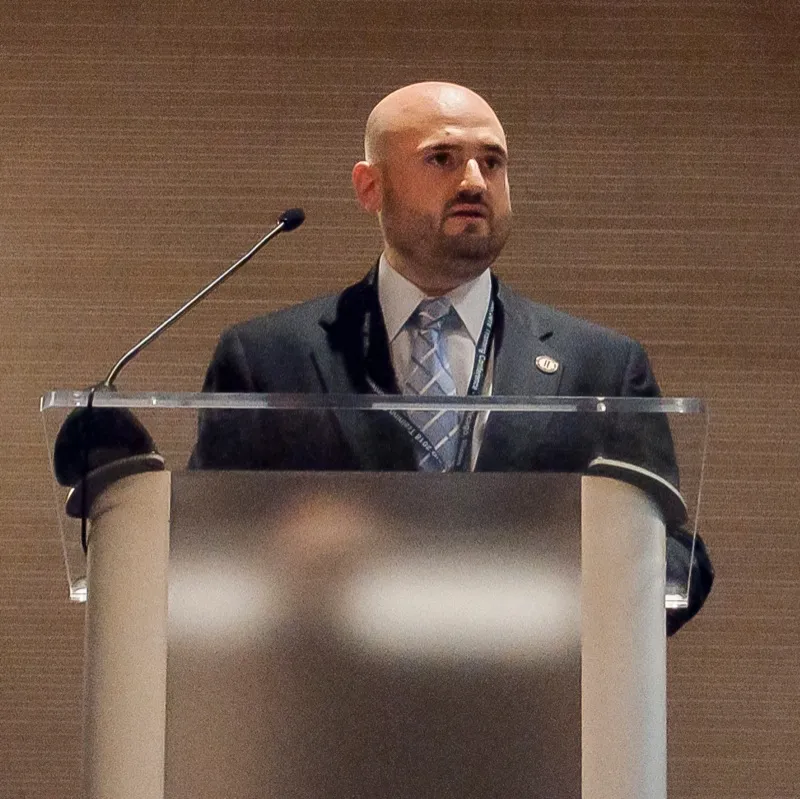 Professor Adam Scott Wandt speaking at a professional conference